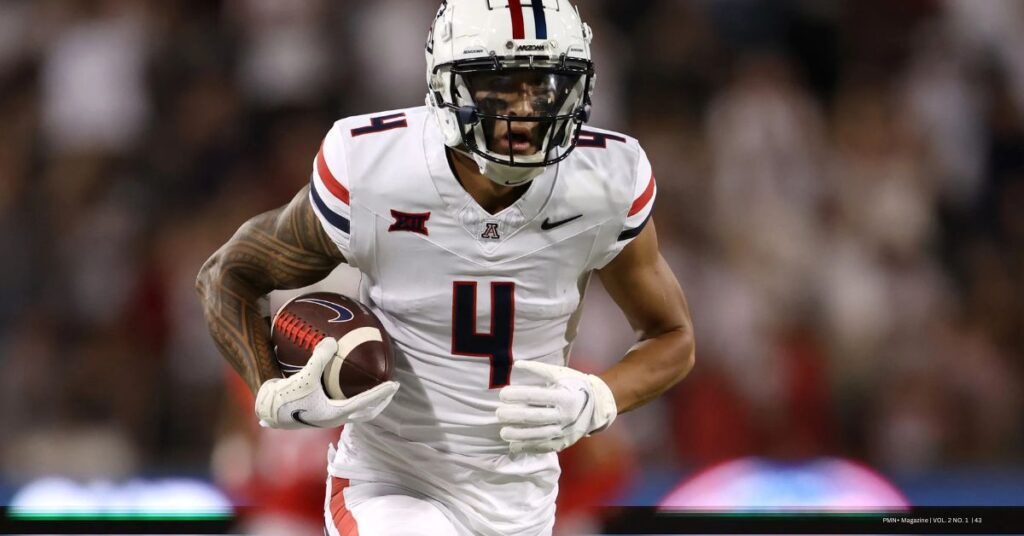 Arizona Wildcats wide receiver Tetairoa McMillan (#4) sprinting downfield with the football during a college game.