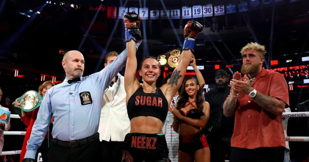 Cherneka “Sugar Neekz” Johnson celebrates her undisputed bantamweight boxing victory at Madison Square Garden with referee raising her arm.