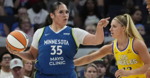 Alissa Pili of the Minnesota Lynx drives against LA Sparks defender Sarah Ashlee Barker during a WNBA game at Target Center on June 21, 2025