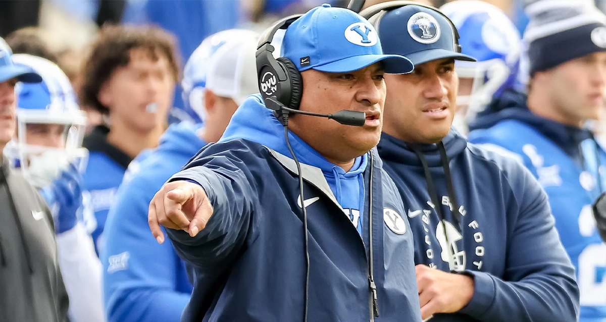 Kalani Sitake, BYU head coach, directing on the sidelines during a game amid Penn State pursuit and contract extension.