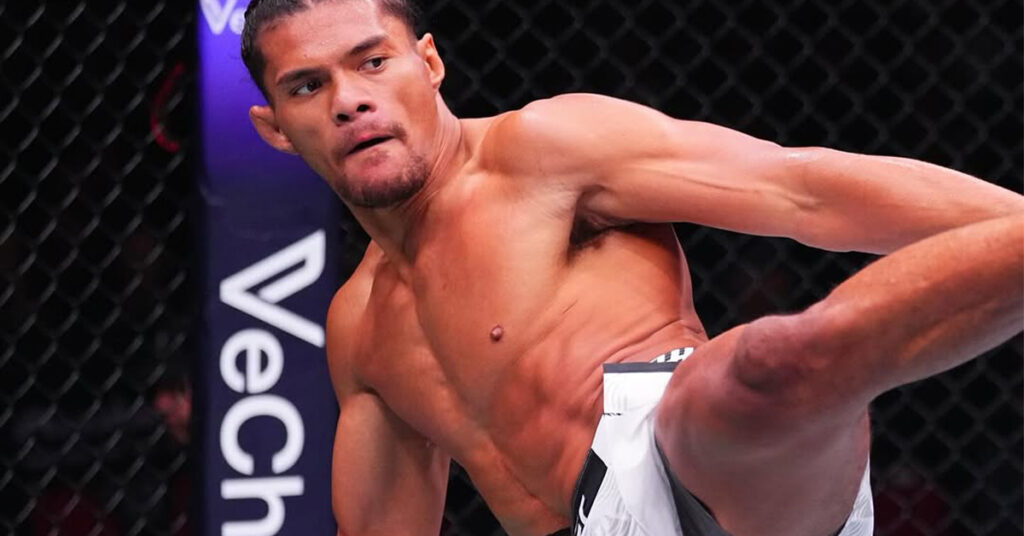 UFC fighter Billy Elekana throwing a powerful strike during his submission victory against Junior Tafa at UFC 325 in Sydney, Australia