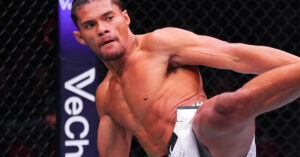 UFC fighter Billy Elekana throwing a powerful strike during his submission victory against Junior Tafa at UFC 325 in Sydney, Australia