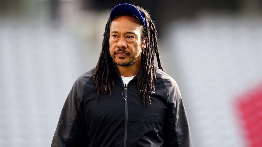 Moana Pasifika head coach Tana Umaga wearing a black team jacket and blue cap during a rugby training session.