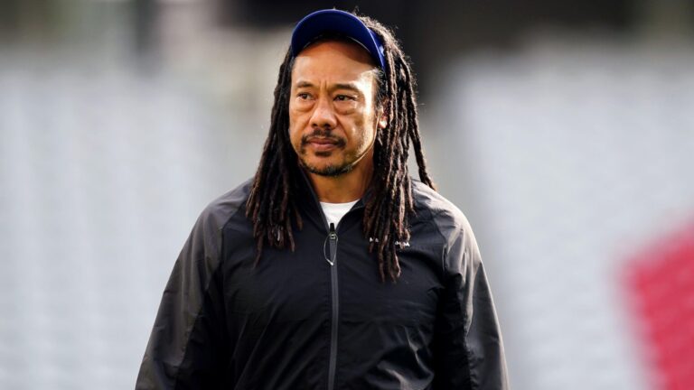 Moana Pasifika head coach Tana Umaga wearing a black team jacket and blue cap during a rugby training session.