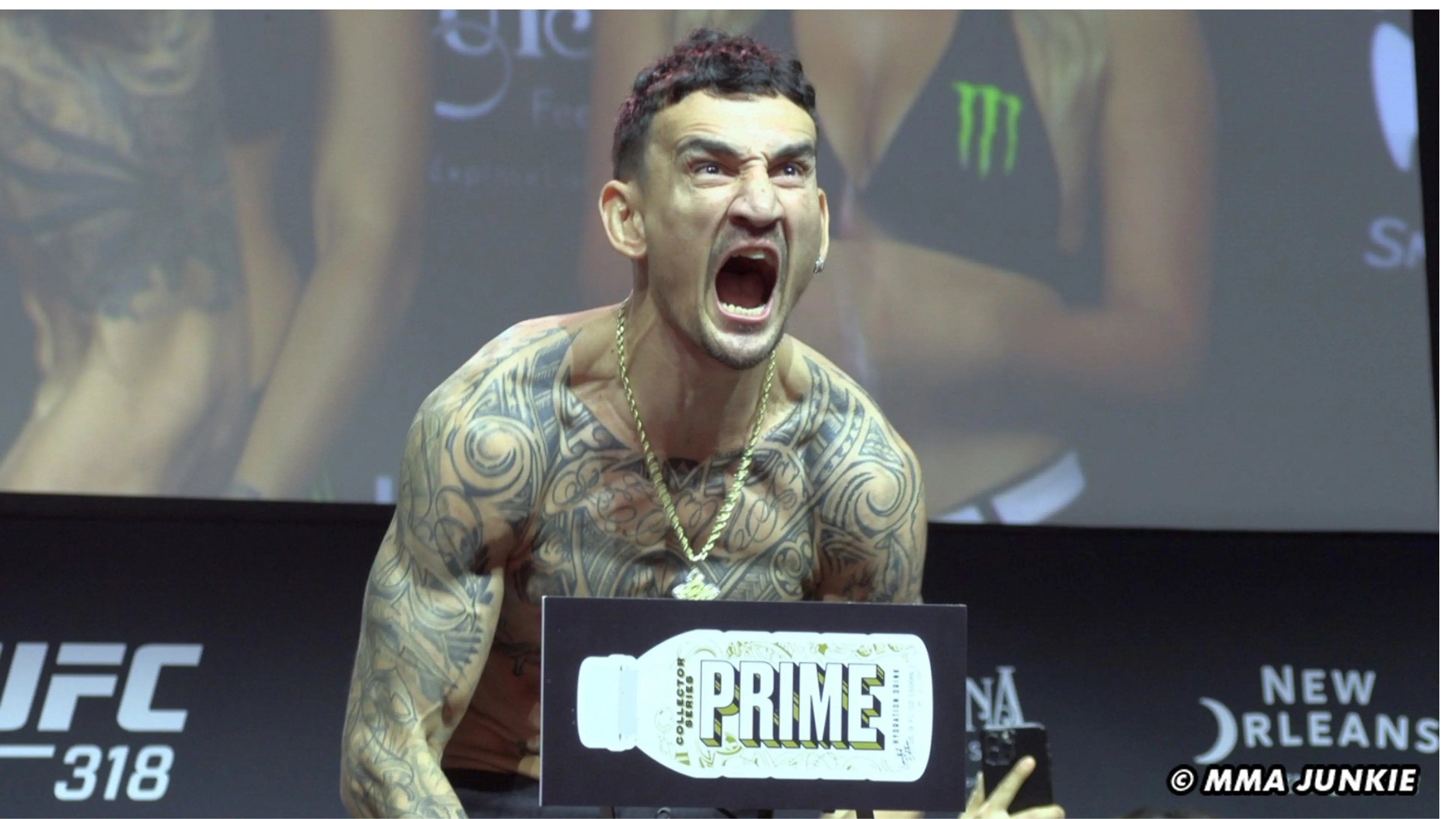 UFC fighter Max Holloway screaming intensely on the scale at the UFC 318 weigh-ins with a Prime Hydration bottle sign in front.