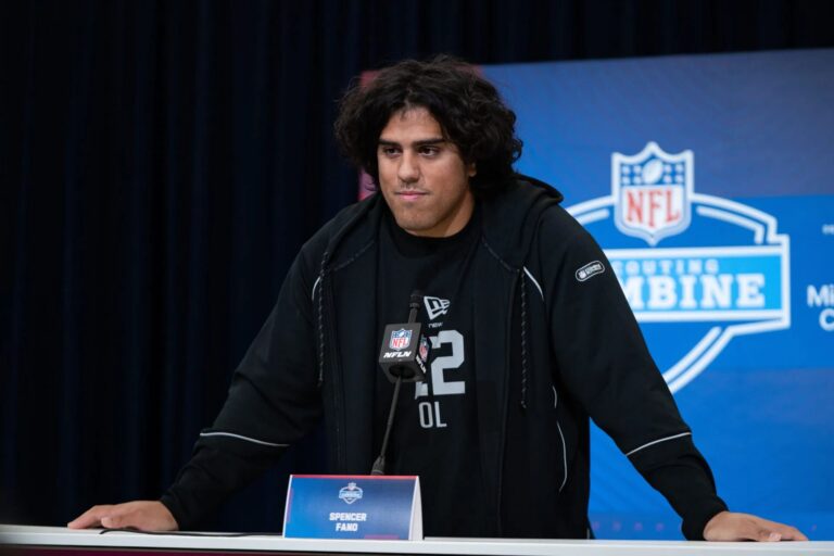 Offensive lineman Spencer Fano speaking at a podium during the NFL Scouting Combine press conference.