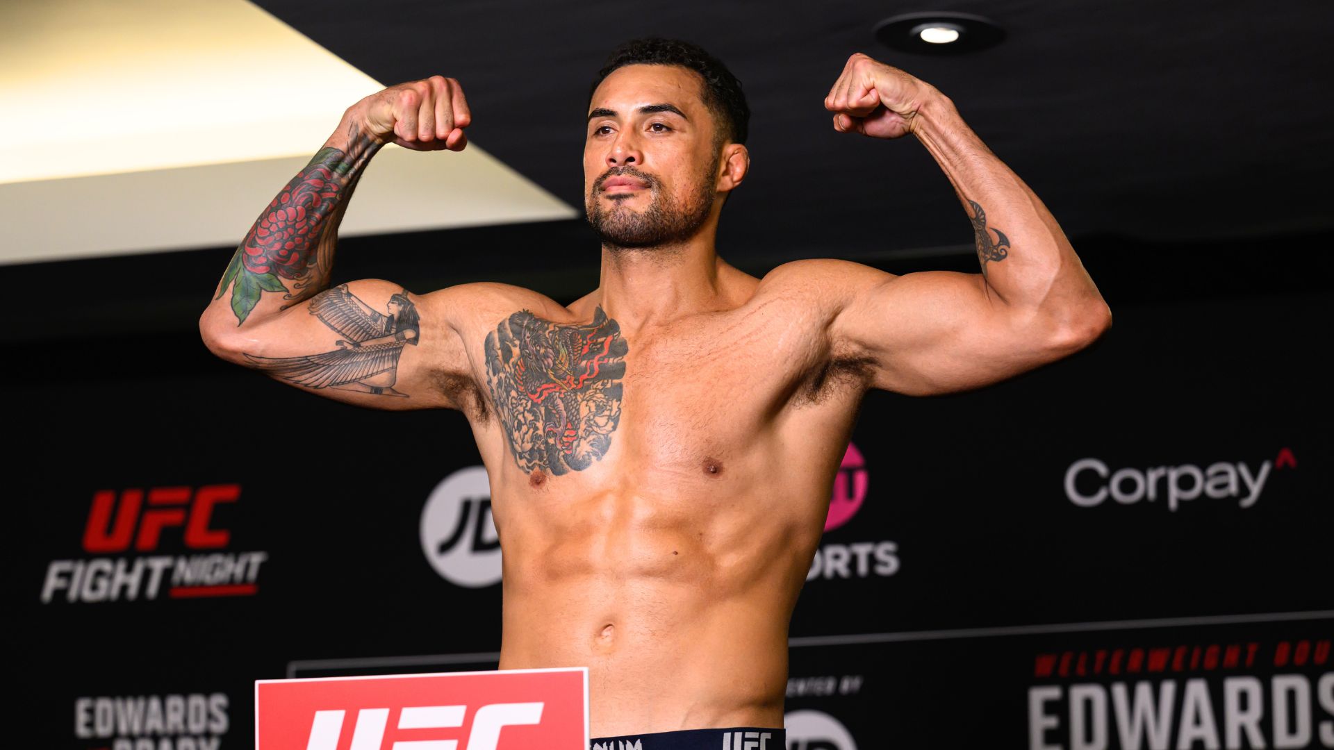 UFC light heavyweight fighter Carlos Ulberg flexing at a UFC Fight Night official weigh-in.