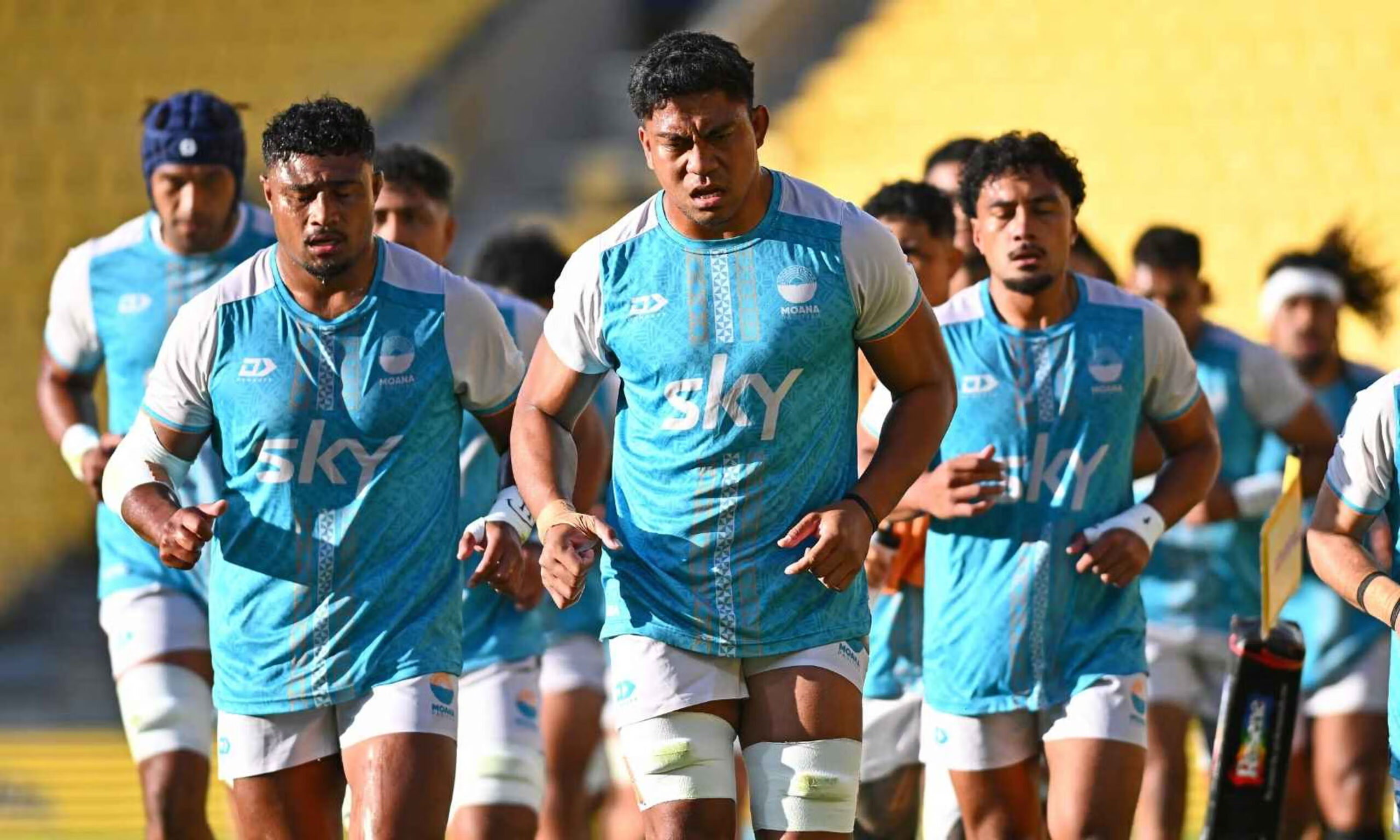 Moana Pasifika rugby players running onto the field during a training session focused on intensity