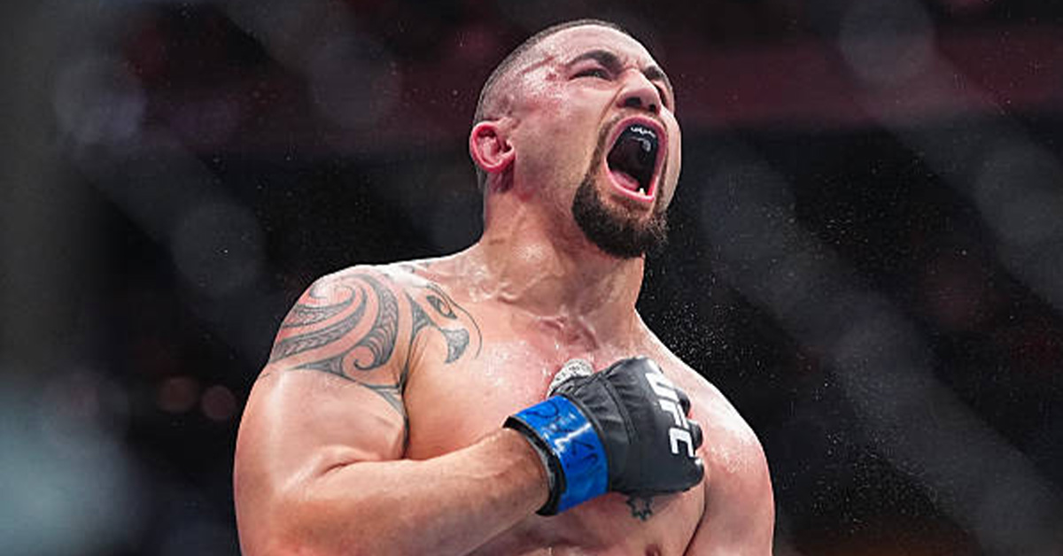 Robert Whittaker lands a straight right on Nikita Krylov during his light heavyweight debut TKO win at UFC 329