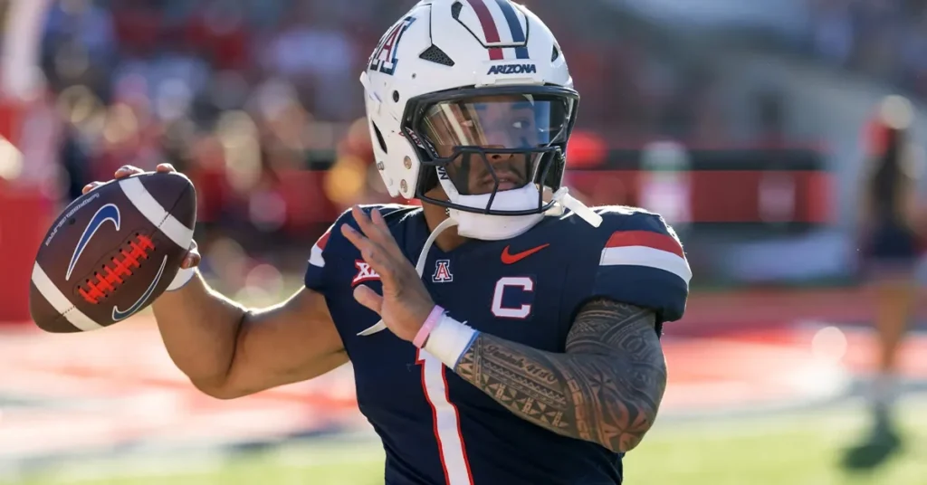Arizona Wildcats quarterback Noah Fifita throws a pass in his navy No. 7 captain's jersey before kickoff