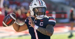 Arizona Wildcats quarterback Noah Fifita throws a pass in his navy No. 7 captain's jersey before kickoff