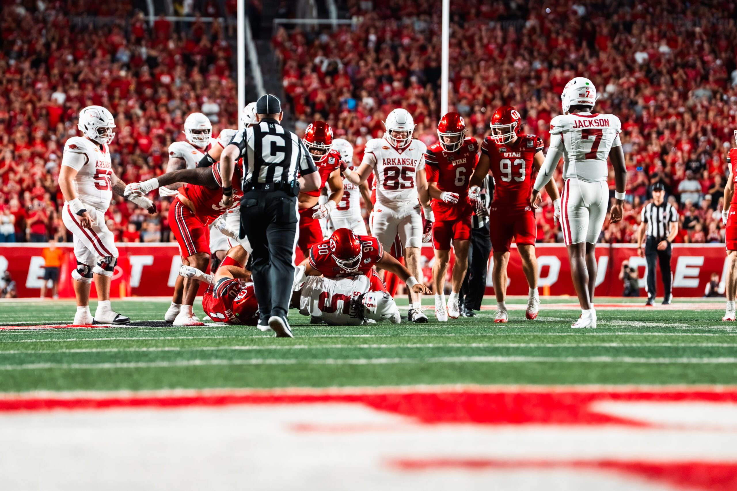 Utah Utes defenders tackle an Arkansas Razorbacks player near the goal line during Utah’s 43–10 home victory.