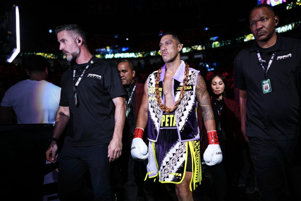 Jai Opetaia walks to the ring at T-Mobile Arena wearing a Samoan ula over his purple and white robe