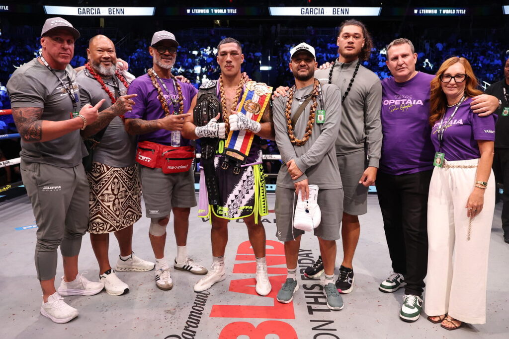 Jai Opetaia and Team Opetaia wearing Samoan ula in the ring with The Ring Magazine and Zuffa Boxing belts