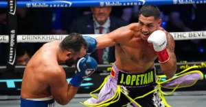 Samoan-Australian cruiserweight champion Jai Opetaia lands a right hand on Noel Mikaelian during their title fight at T-Mobile Arena