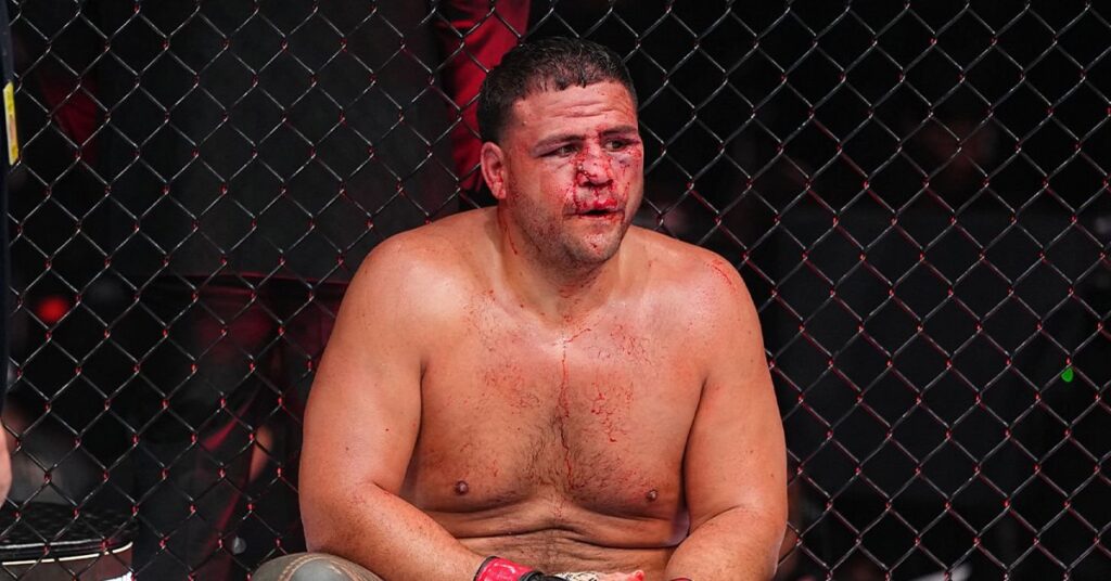 Tai Tuivasa sits against the Octagon fence, bloodied after his split decision loss to Robelis Despaigne at UFC 331 in Los Angeles