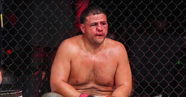 Tai Tuivasa sits against the Octagon fence, bloodied after his split decision loss to Robelis Despaigne at UFC 331 in Los Angeles