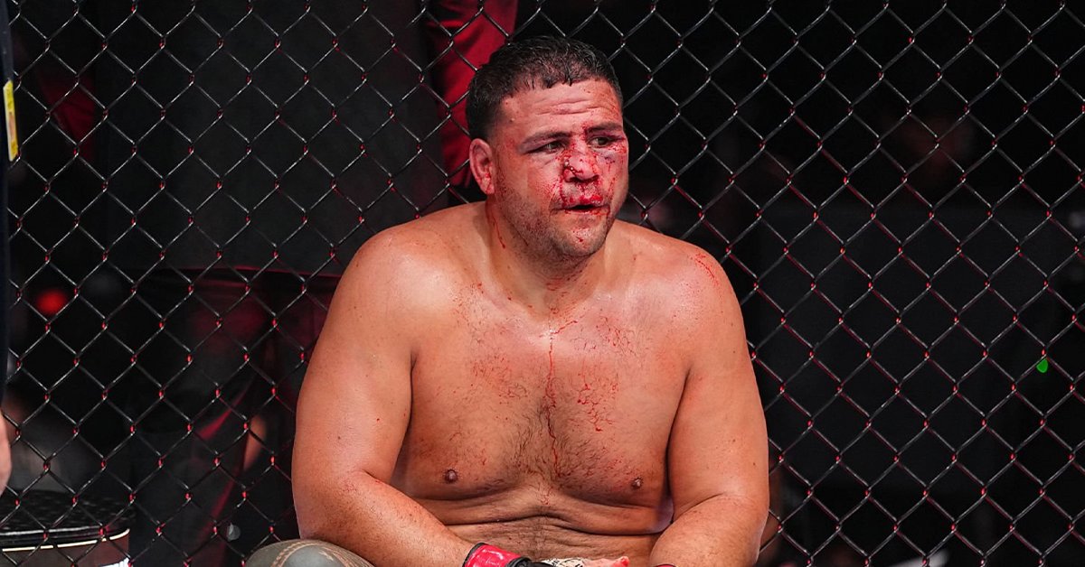 Tai Tuivasa sits against the Octagon fence, bloodied after his split decision loss to Robelis Despaigne at UFC 331 in Los Angeles